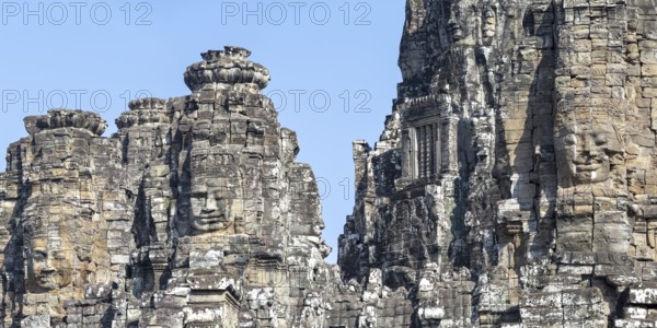 Panoramic image of giant stone-carved faces of the Bodhisattva Lokeshvara, also known as