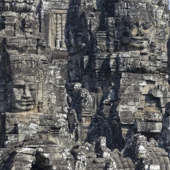 Panoramic image of giant stone-carved faces of the Bodhisattva Lokeshvara, also known as