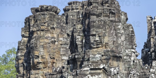 Panoramic image of giant stone-carved faces of the Bodhisattva Lokeshvara, also known as