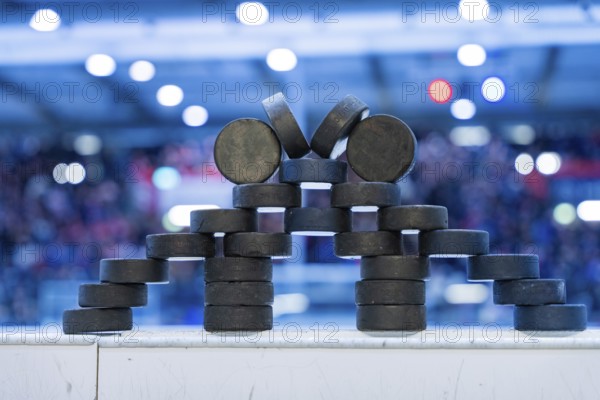 Stack of ice hockey pucks artfully arranged on the sidelines, Heilbronner Falken Vs Bietigheimer