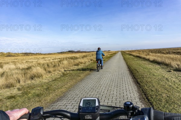 The East Frisian North Sea island of Juist in winter, cycling in the west of the island, on dyke