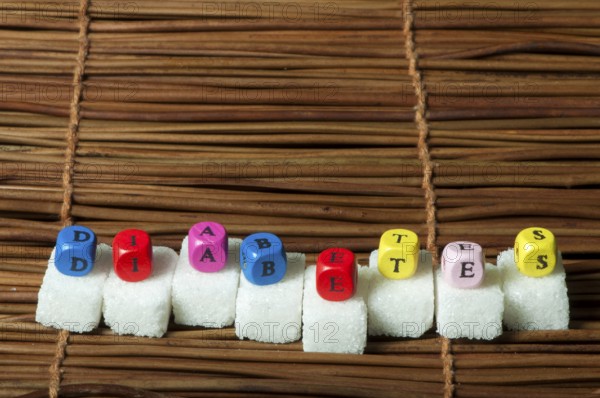 Sugar lumps and word diabetes. Multicoloured cubes