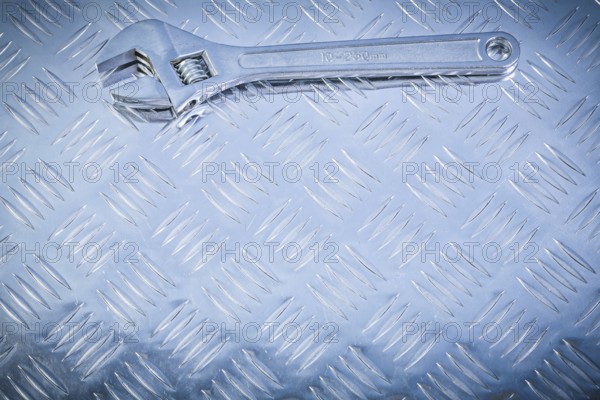 Adjustable tensioner on fluted metal background construction concept
