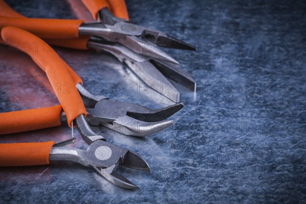 Collection of insulated cutting pliers gripping tongs with rubber handles