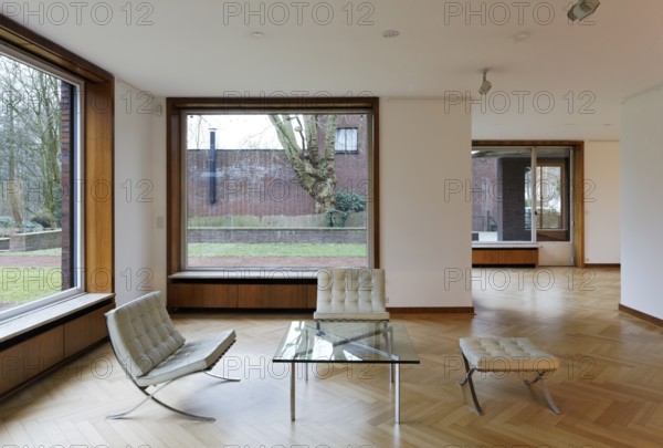 Interior (living room with retractable windows) of Haus Lange with a view of the garden to the east