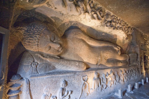 Huge figure of reclining buddha laying back in preparation for nirvana at ajanta caves, Aurangabad,