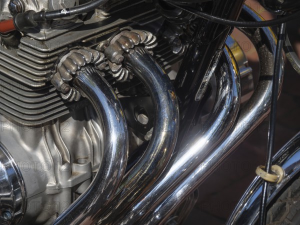 Detailed view of shiny chrome-plated motorbike exhaust pipes and engine parts, Appelhülsen,