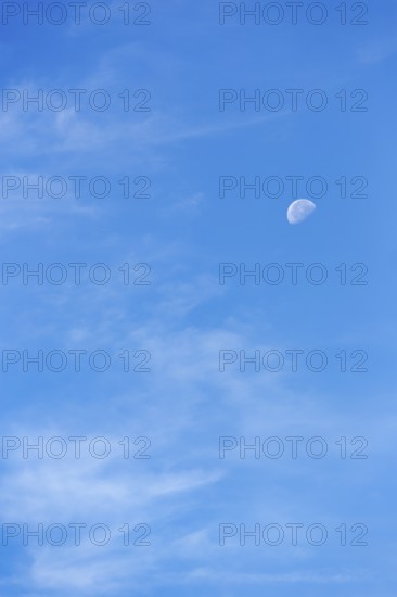 Light clouds in blue sky, waning moon, blurred, full-frame, East Sussex, South Downs, England,