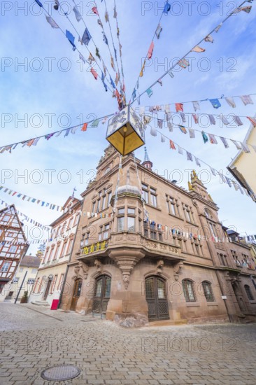Historic building with colourful pennants on a cobblestone square, Meßkirch, Sigmaringen district,