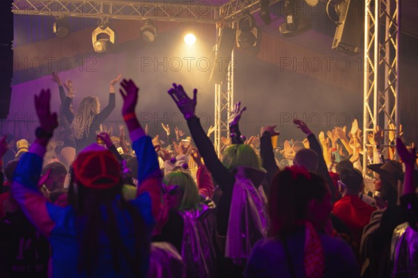 The audience raises its hands in a joyful mood at a concert, carnival, Schlagerkuchen Donzdorf,