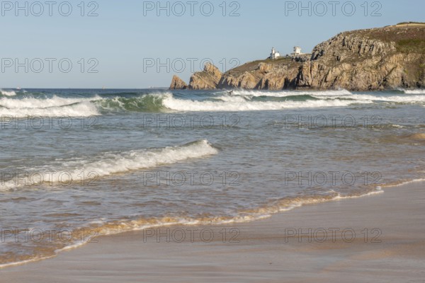 The sea is calm and the beach is sandy. The waves are small and the water is a light blue colour.
