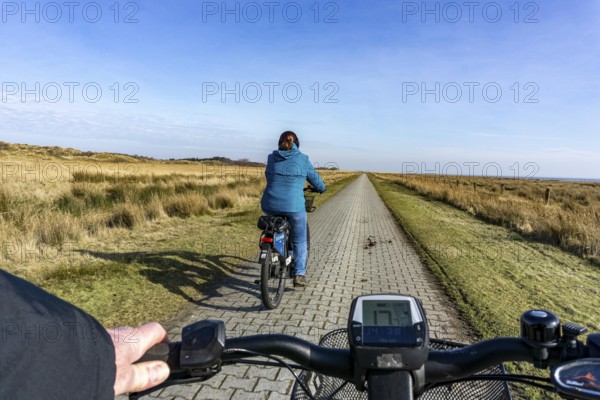 The East Frisian North Sea island of Juist in winter, cycling in the west of the island, on dyke