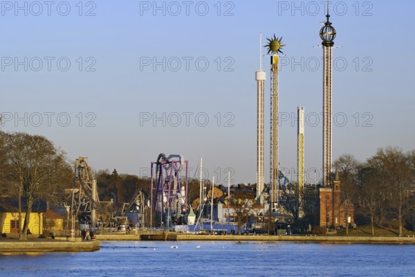 Amusement park with various rides under a clear sky, Djurgarden, Stockholm, Sweden, Europe