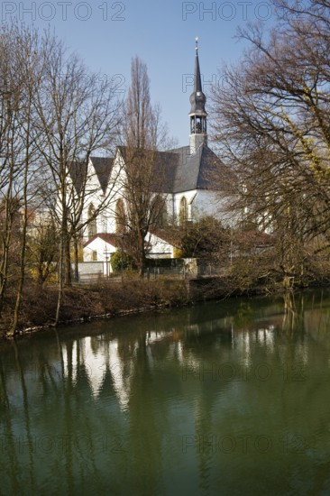 The Church of the Brethren is reflected in the River Lippe in spring in Lippstadt, North