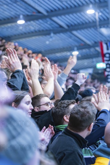 Cheering spectators in the stadium clap and raise their hands, Heilbronner Falken Vs Bietigheimer