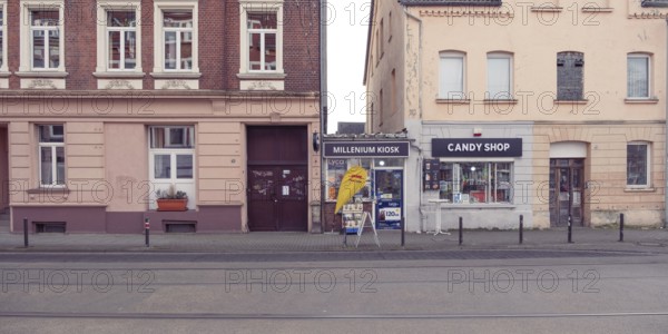 View of a house facade with a small kiosk between two houses, old, historical, entrance door, city,