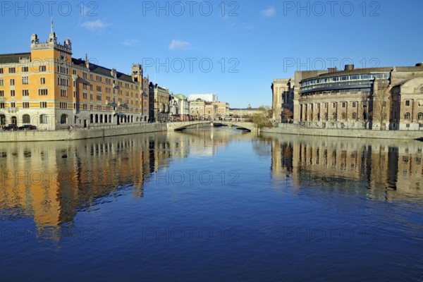 Symmetrical view of a river with bridge and city buildings, Riksdag, capital city, Stockholm,
