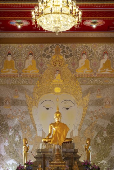 Golden Buddha statue with tunic, Bhumispara-mudra, Buddha Gautama at the moment of enlightenment,