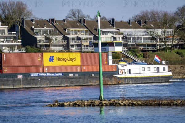 Container cargo ship on the Rhine near Düsseldorf-Bockum, villas on the banks of the Rhine, the