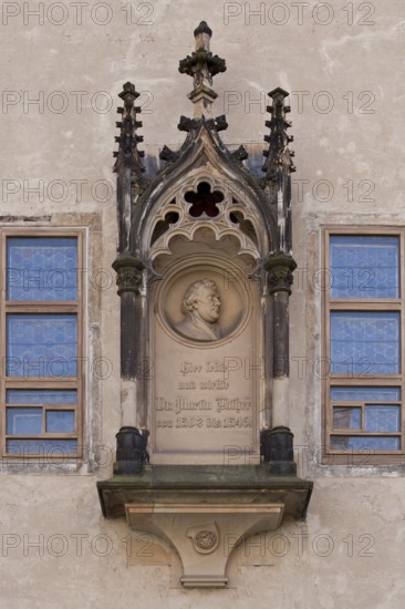 Tracery canopy on the outside between the windows of the Luther Room, containing a medallion with a