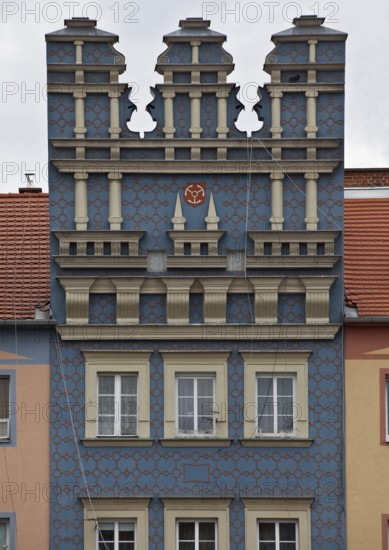 Renaissance ornamentation on a town house with town coat of arms consisting of three anchors