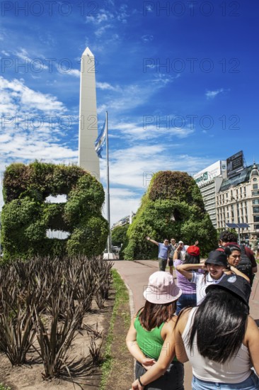 Tourists photograph themselves in front of the plant gates in the shape of the letters of Buenos