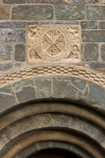 Coll, Santa Maria de l'Assumpció, west portal with Christ's monogram