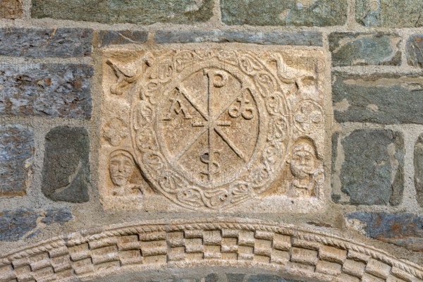 Coll, Santa Maria de l'Assumpció, west portal with Christ's monogram