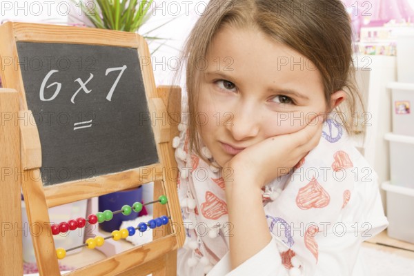 Frustration at school, arithmetic, lack of concentration, 7 year old girl looks unhappy and
