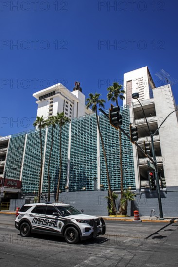 Marshal patrols in front of Art Deco façade, car park of Binions Casino Hotel, Downtown, Las Vegas,