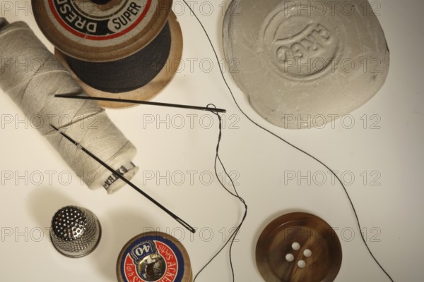 Sewing supplies, needle, thimble, button, knob, ? pin?, sewing thread, sewing-thread, sew on