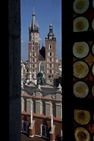 View through a coloured glass window of the town hall tower to St. Mary's Church, below Tuchhallen,