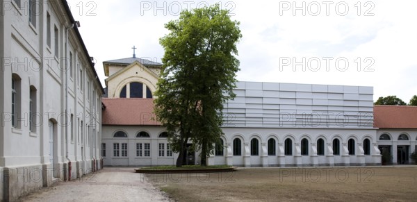 Concert hall in former riding arena, castle church behind it
