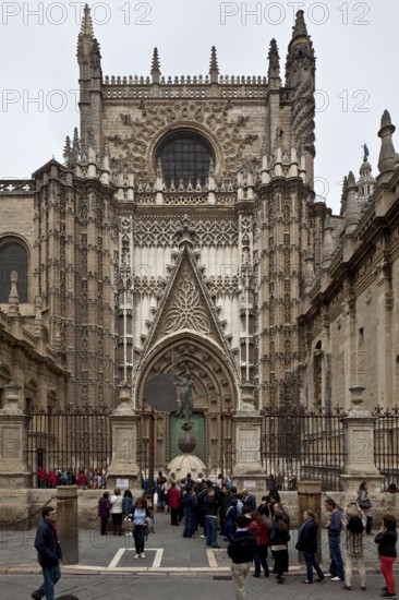 Seville, Cathedral. South portal in front of it Original of the bronze sculpture crowning the bell