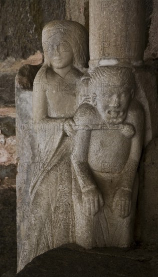 Collegiate church, south portal, woman ties up devil with chain, St., Saint, Saint