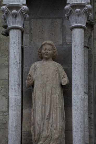Sculpture of a youth in the central buttress canopy on the north side of the three western nave