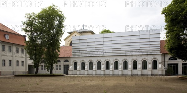 Concert hall in former riding arena, castle church behind it