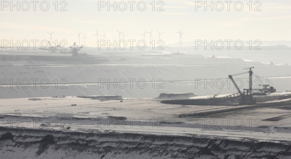 Landscape in the snow, wind turbines in the background