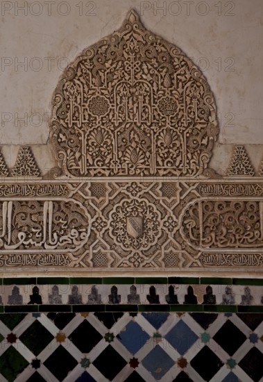 Nasrid palace, tree of life motif, stucco wall decoration with calligraphic elements on a tiled