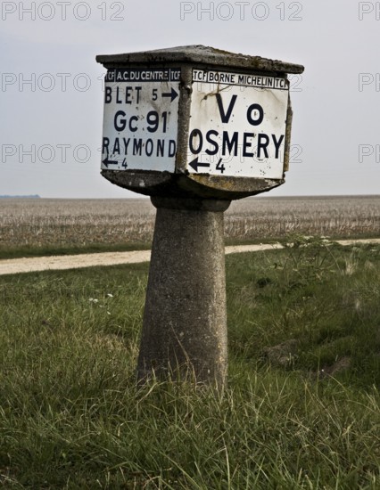 Historic concrete signpost, cube on column