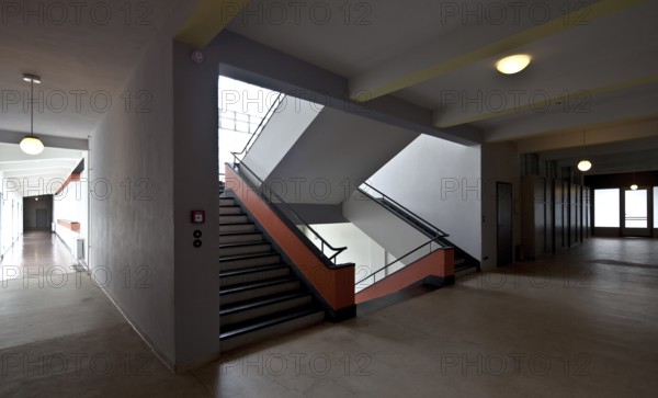 First floor, view of the staircase and corridor of the former vocational school, bridge on the left