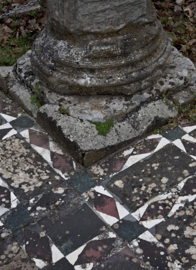 Column base on mosaic floor