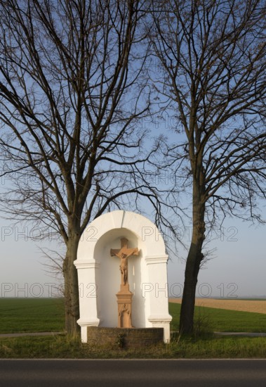 Wayside shrine from the 18th century flanked by two lime trees