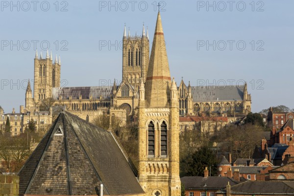 Church of Saint Hugh in foreground with towers of cathedral behind, Lincoln, Lincolnshire, England,