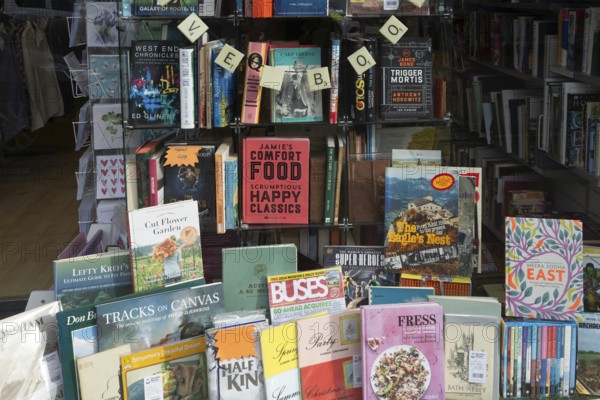 Shop window display of secondhand books in Dorothy House charity shop, Chippenham, Wiltshire,