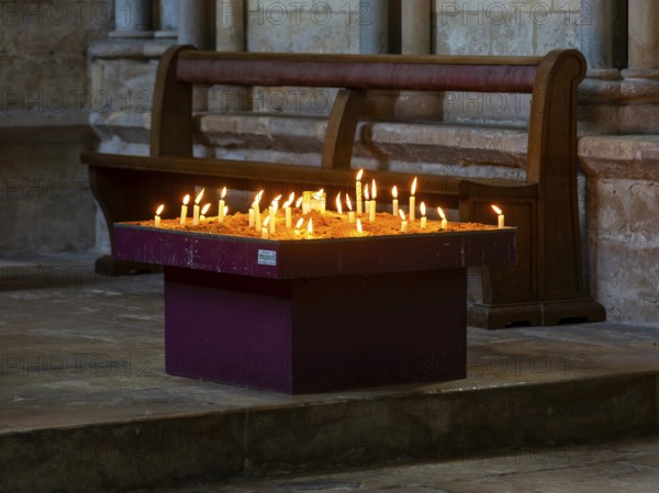 Lit candles burning inside cathedral, city of Lincoln, Lincolnshire, England, UK