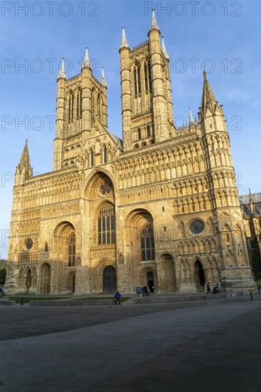 West frontage of cathedral church in evening light, Lincoln, Lincolnshire, England, UK