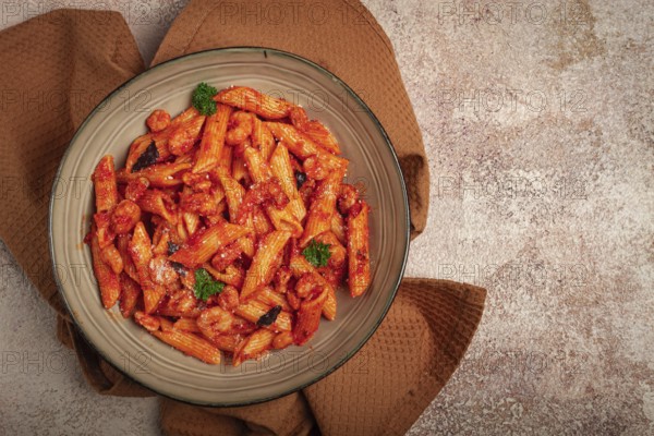 Penne pasta, with shrimp in tomato sauce, close-up, no people
