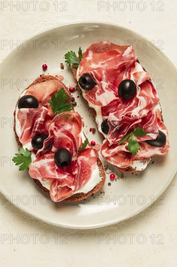 Sandwich with cream cheese, prosciutto with olives, breakfast