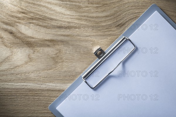 Clipboard blank paper on wooden board